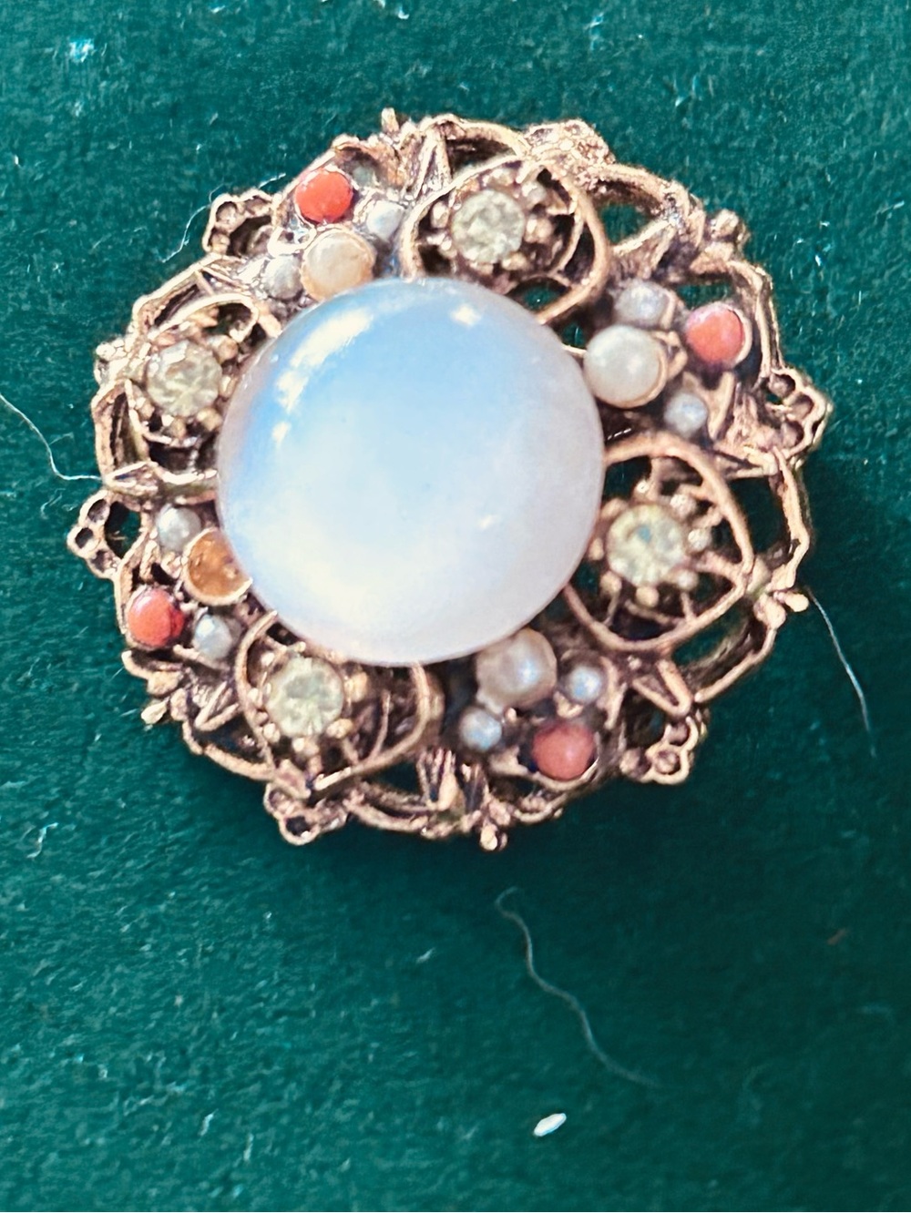 Vintage-Inspired Gold Tone Filigree Brooch with Opalescent Center